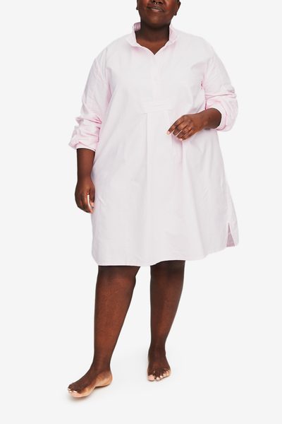 Lydia wears the Plus size version of our classic nightshirt. Shown here in Pink Oxford Stripe, the sleeve are loosely rolled to the elbow and the placket has a couple buttons unbuttoned for an effortless look.