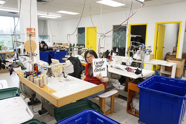 Factory worker holding sign from Fashion Revolution, I made your clothes campaign