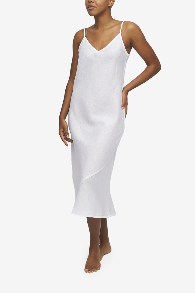 A midi length, V-neck slip dress with adjustable spaghetti straps. Made form out timeless White Linen and cut on the bias for ultimate fit. 