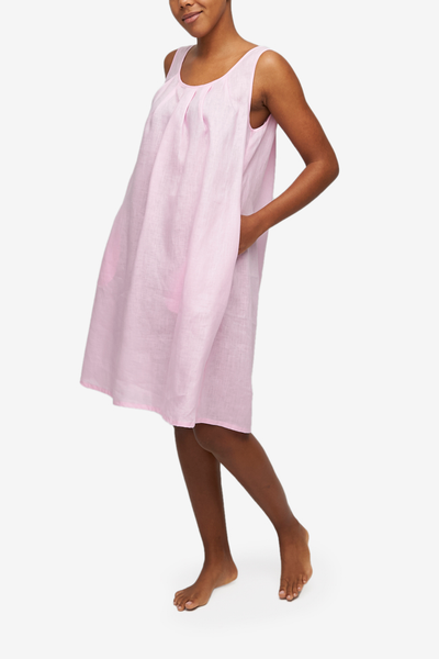 Sleeveless pink linen nightgown, knee-length with an A-line silhouette. Inseam pockets.