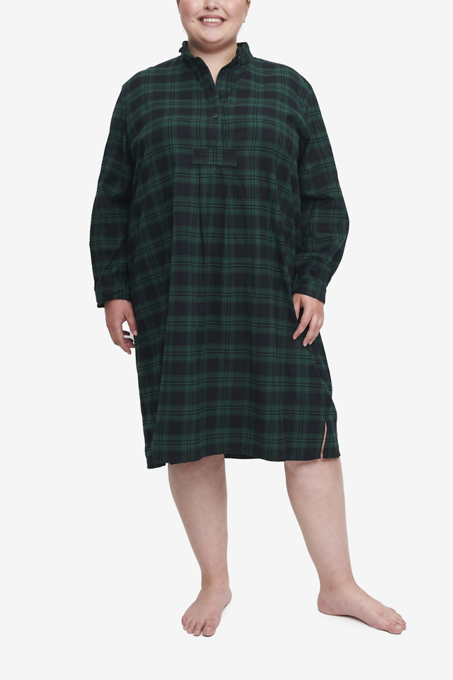 Plus size long nightshirt with high collar and long sleeves. Made in a luxurious dark black and green check cotton flannel. Hem will hit below the knee.