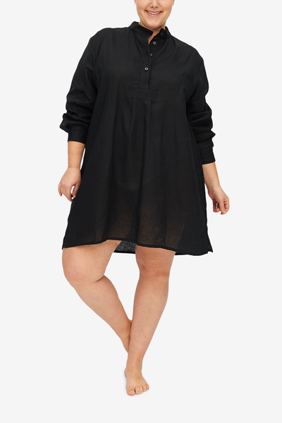 Charlotte looks cute while balancing on one foot with her legs crossed at the ankles. The black linen short sleep shirt hangs beautifully and looks luxurious.