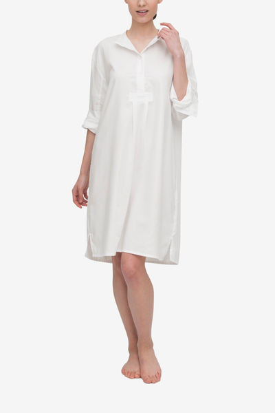 A traditional nightshirt in a classic white royal oxford shirting. The placket has the top two buttons open to show that the collar can be worn folded down.  