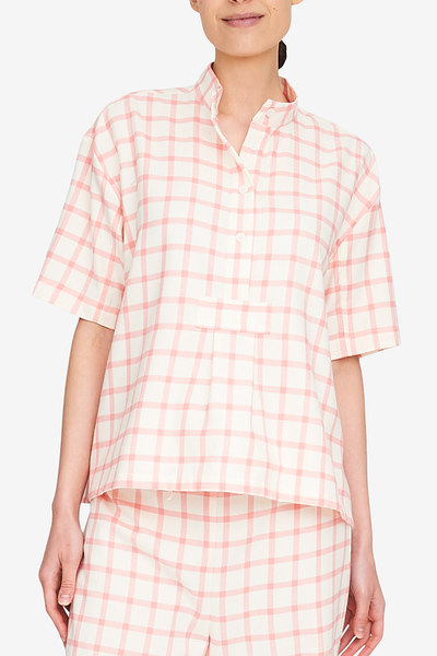 Front view of the Short Sleeve Cropped Shirt, a hip-length version of our classic shirts. This cream and pink flannel is cute and will only get better with washing and wearing. Looks great with the matching pants on on its own with jeans. 