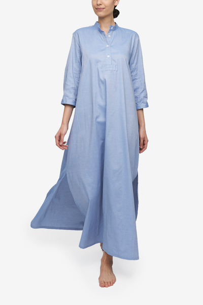 A full length chemise in a medium blue oxford cotton fabric. This nightshirt has a stand collar, a three quarterplacket and sleeves. Side slits make this piece move beautifully while prioritizing comfort.
