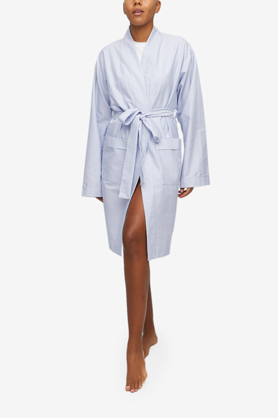 Unisex robe for men and women, made in Canada. Long sleeves, shawl collar, two patch pockets and matching belt. Blue and white striped oxford cotton.