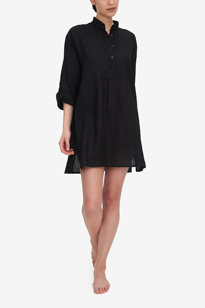 Front view of the short version of our classic long nightshirt. Shown here in Black linen, the model is swinging her arms as she walks towards the camera. The black linen shirt hits her about mid-thigh but she's our supermodel so it'll be a bit longer than that on most.