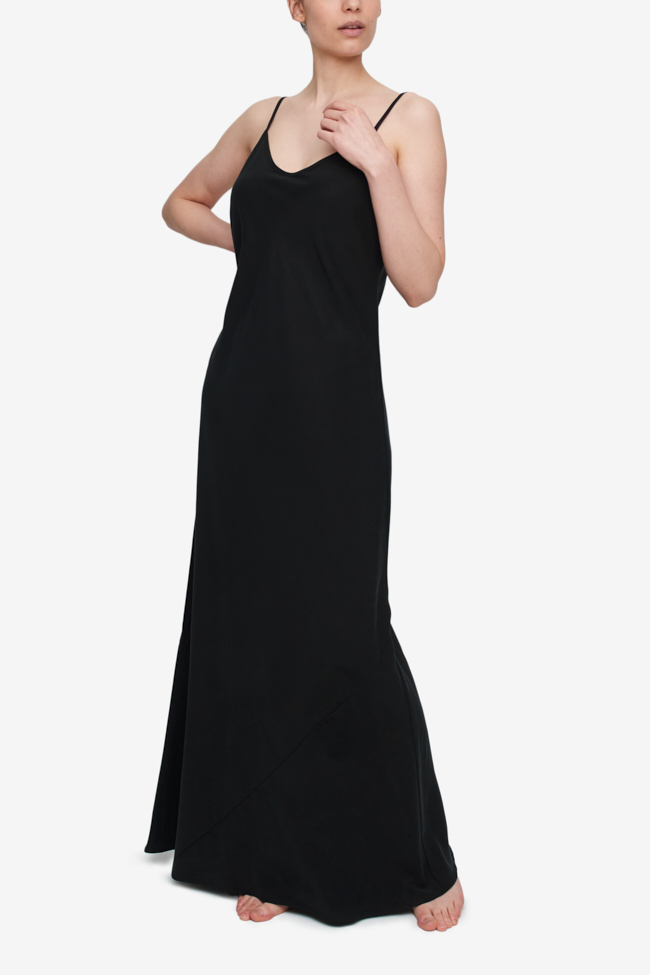 A floor length bias cut slip dress in a solid black tencel fabric. Adjustable spaghetti straps and a slight sweetheart neckline. Slim at the bust and wide at them hem.