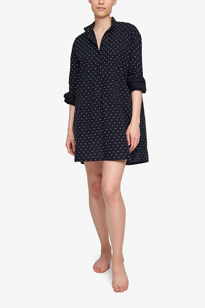 A textured, white on dark blue swiss dot cotton fabric, high-quality luxury sleepwear for women made in Canada. 
