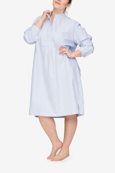 Front view of the Plus version of our classic long nightshirt. Shown here in Blue Oxford Stripe, the model is holding the collar away from her body to show off the three quarter placket.