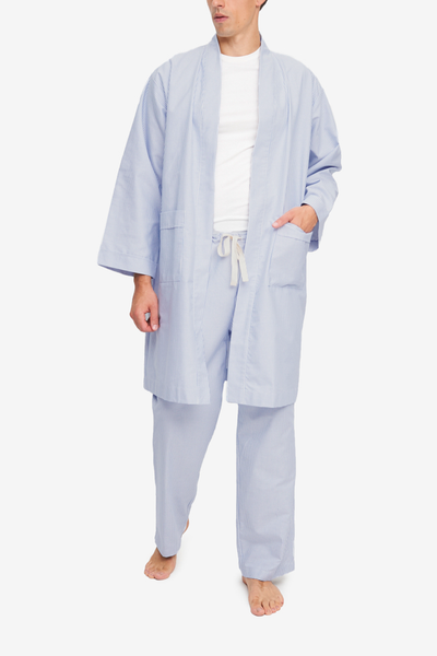 Unisex robe for men, blue and white striped oxford cloth cotton. Knee-length, patch pockets. Can be worn open or belted closed.
