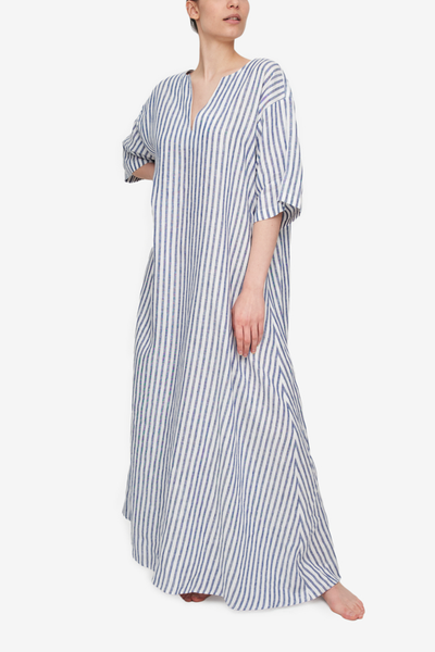 A floor length, a-line kaftan chemise in a blue and white vertical stripe linen. Elbow length sleeve, oversized fit for silhouette and comfort.