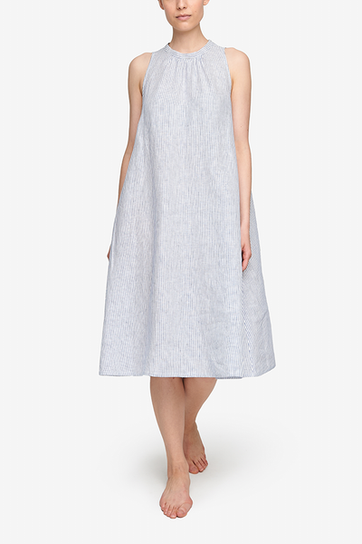 below the knee length nightgown or day dress in blue and white striped linen. A-line silhouette, no sleeves, high collar.