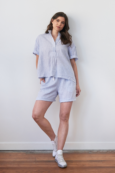 editorial shot of the short sleeve top and matching short pyjama set made in a luxury linen, blue and white stripes. Made in canada, long lasting.