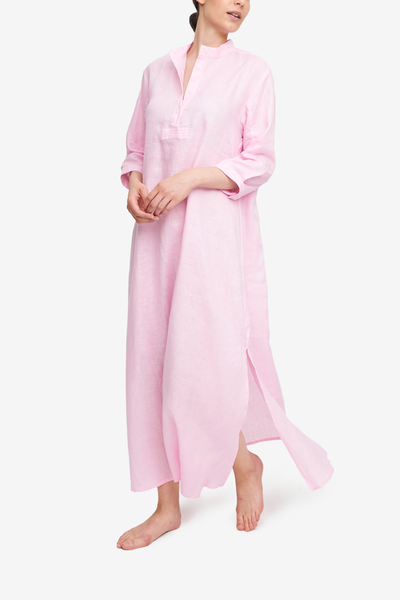 Full length night shirt with three quarter sleeves. Placket and stand collar. Made from a light pink linen.