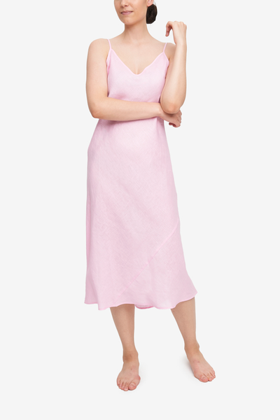 Midi-length, bias cut slip dress with spaghetti straps. Light pink, 100% linen.
