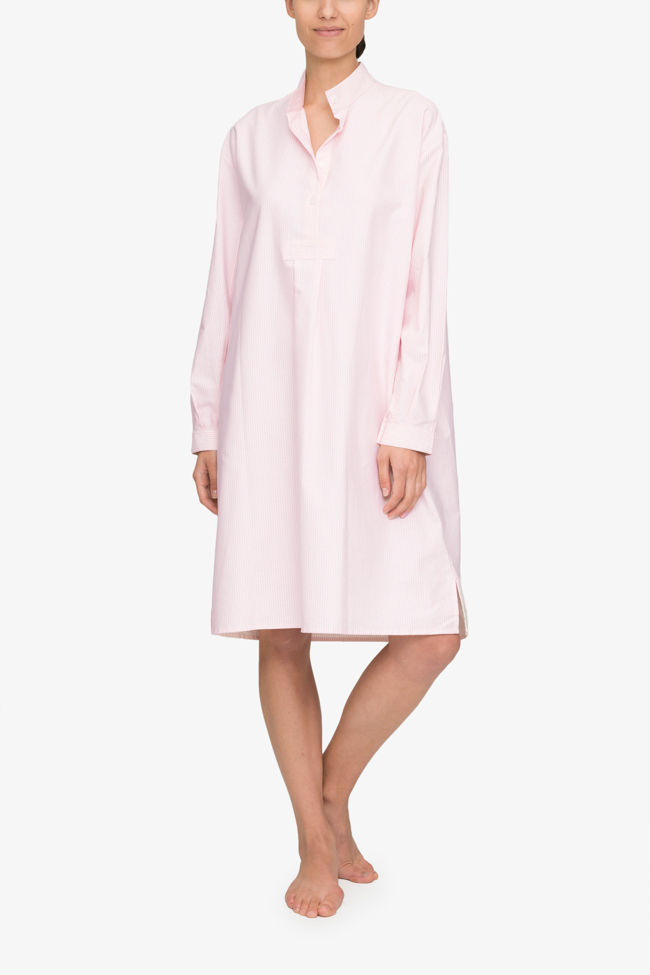 Emily wears the below the knee length, long version of our classic nightshirt. Shown here in Pink Oxford Stripe, it has long sleeves and a stand collar with a couple buttons open on the three quarter placket.