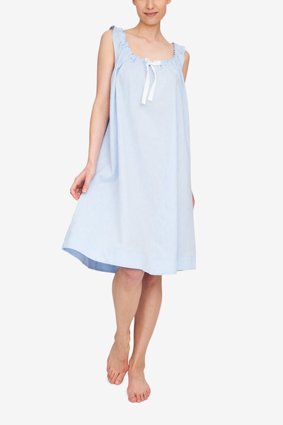 Front view of the Sleeveless Nightie, it's knee length and has a unique gathered necking with the bow tied at centre front. Shown here in a light blue linen cotton blend fabric.