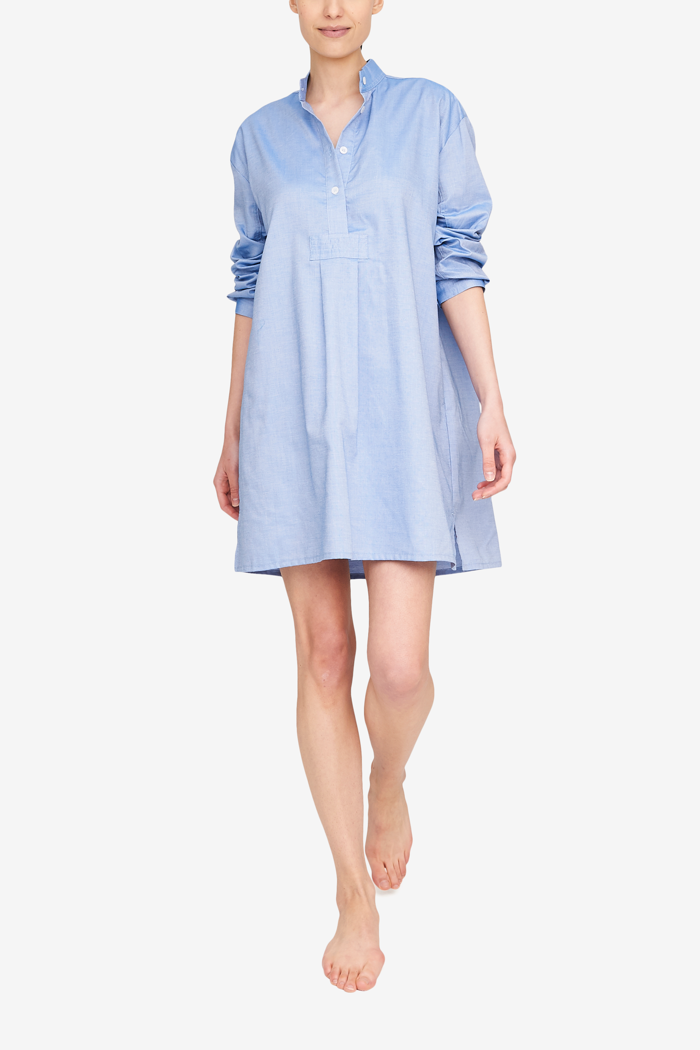 Front view of the Short Sleep shirt in a blue cotton oxford shirting. The sleeves are cuffed and full length, the shirt hits just above the knee for people of an average height.