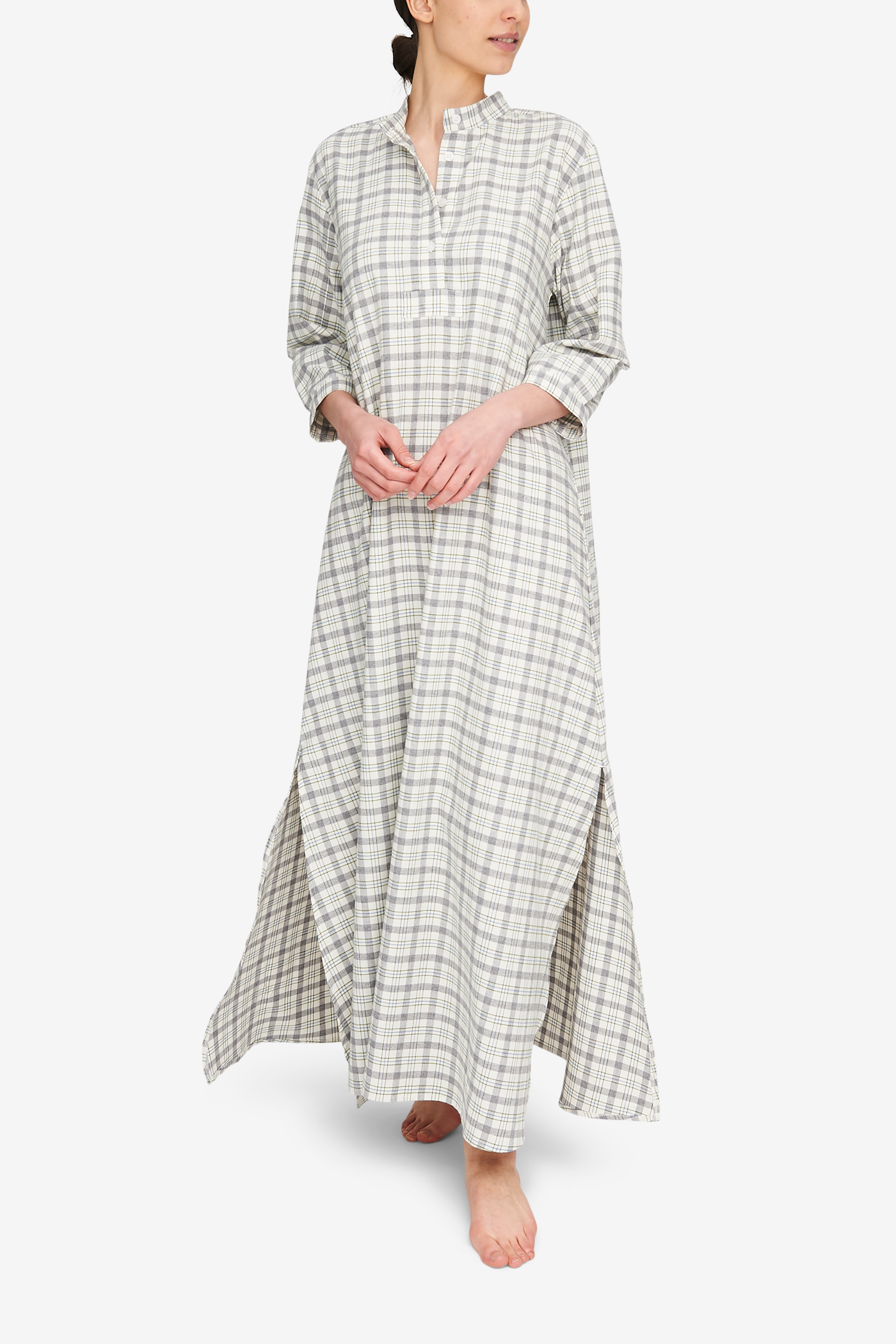 A woman wearing a full length Sleep Shirt. It's a super soft, lightweight, cream and grey plaid flannel.