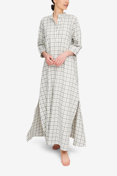 A woman wearing a full length Sleep Shirt. It's a super soft, lightweight, cream and grey plaid flannel.