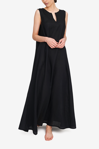 Front view of the sleeveless, floor length day dress in our best selling black linen. Split neckline makes it feminine, the exaggerated a-line silhouette gives ease of movement and drama. 