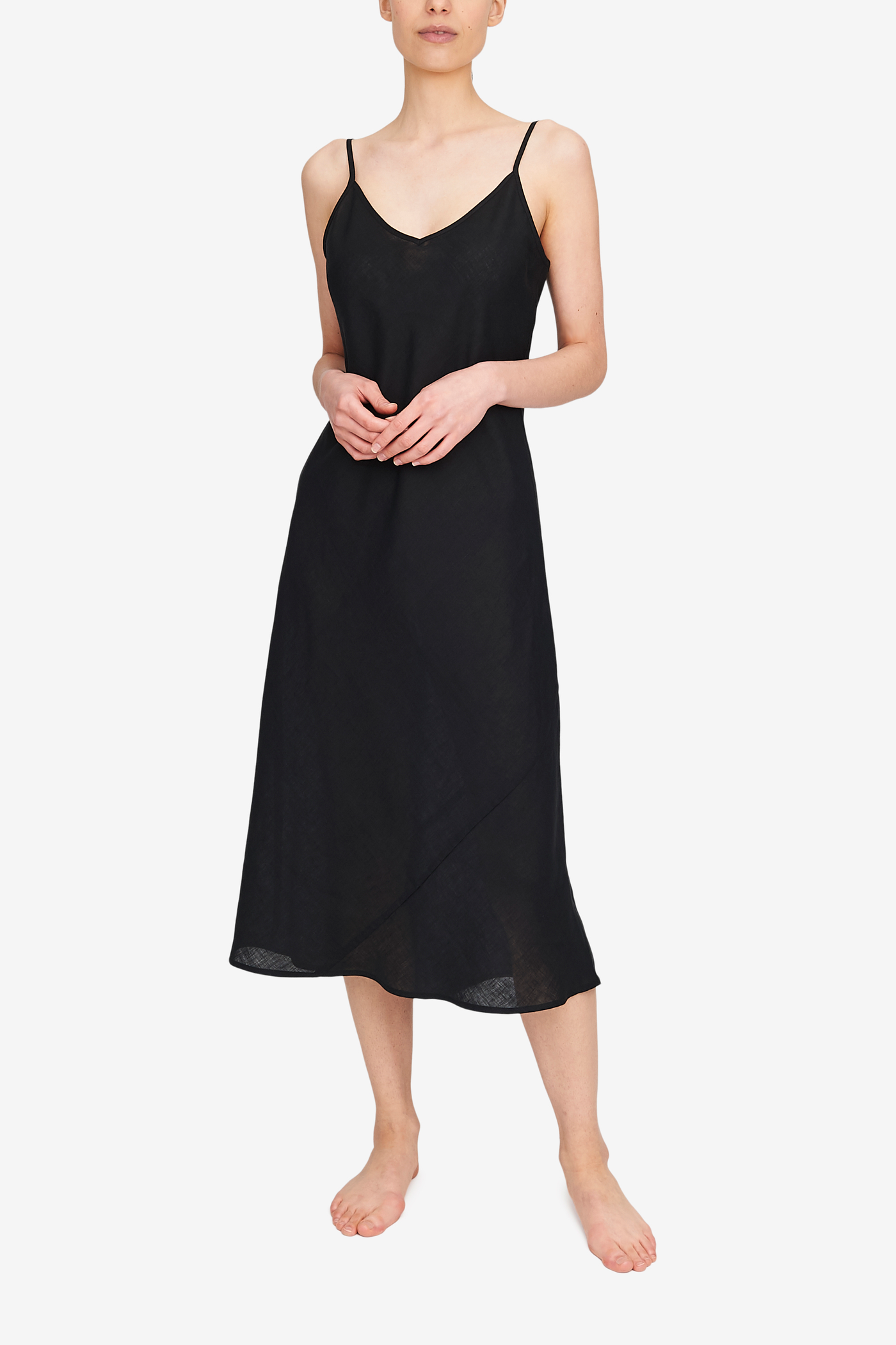 Midi length skip dress made in black linen. Adjustable spaghetti straps, v-neck, cut on the bias for the ultimate fit.