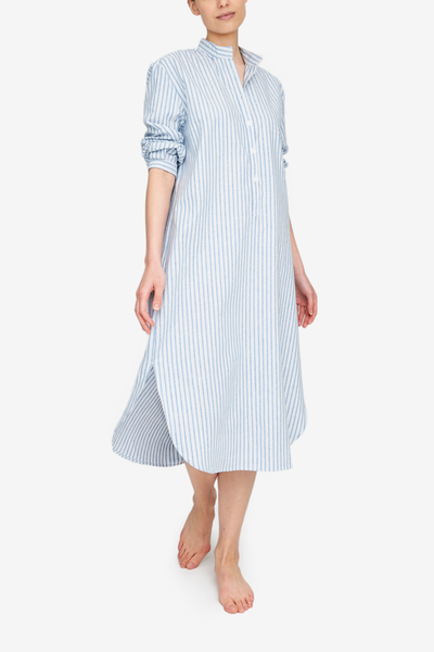 A long, slim nightshirt with three quarter sleeve and a stand collar. It's made in a luxuriously soft cotton linen blend with a vertical blue and white stripe.