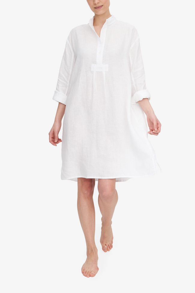 Emily walks towards the camera, making the white linen of the Long Sleep Shirt she is wearing swing. The full length sleeves are rolled up and the collar us undone, she looks confident and relaxed.